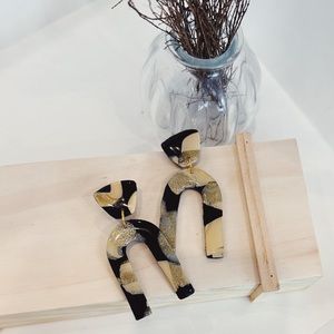 Polymer clay earrings with a resin finish.